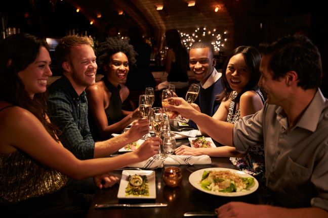 Group of friends eating at restaurant