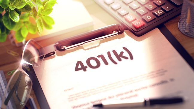 401(k) plan investing overview on clipboard on table with calculator, pen, glasses